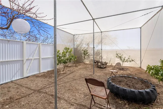 a backyard of a house with table and chairs
