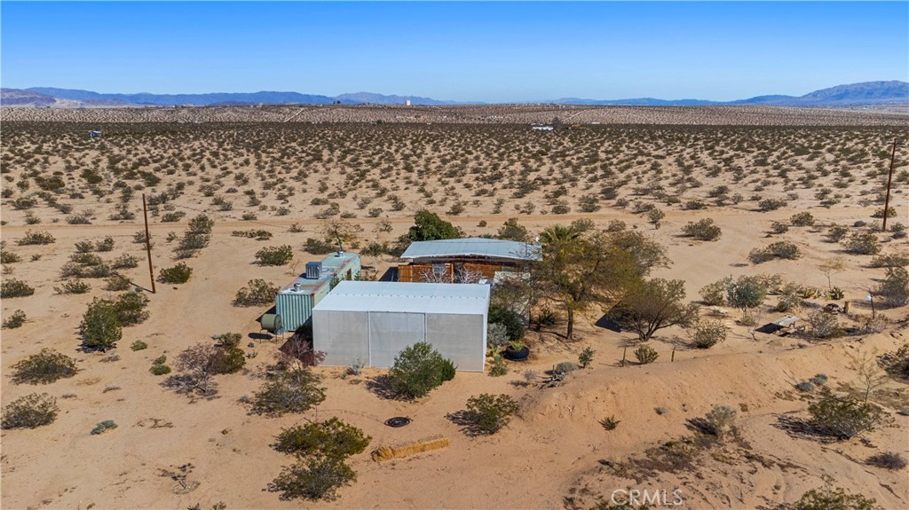 1356 Enchanted Road Joshua Tree, CA 92252 - Photo 45 of 47 a view of a large building with a yard