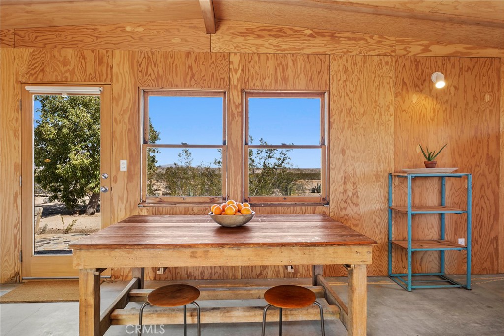 1356 Enchanted Road Joshua Tree, CA 92252 - Photo 6 of 47 a living room with a sink and a table with chairs