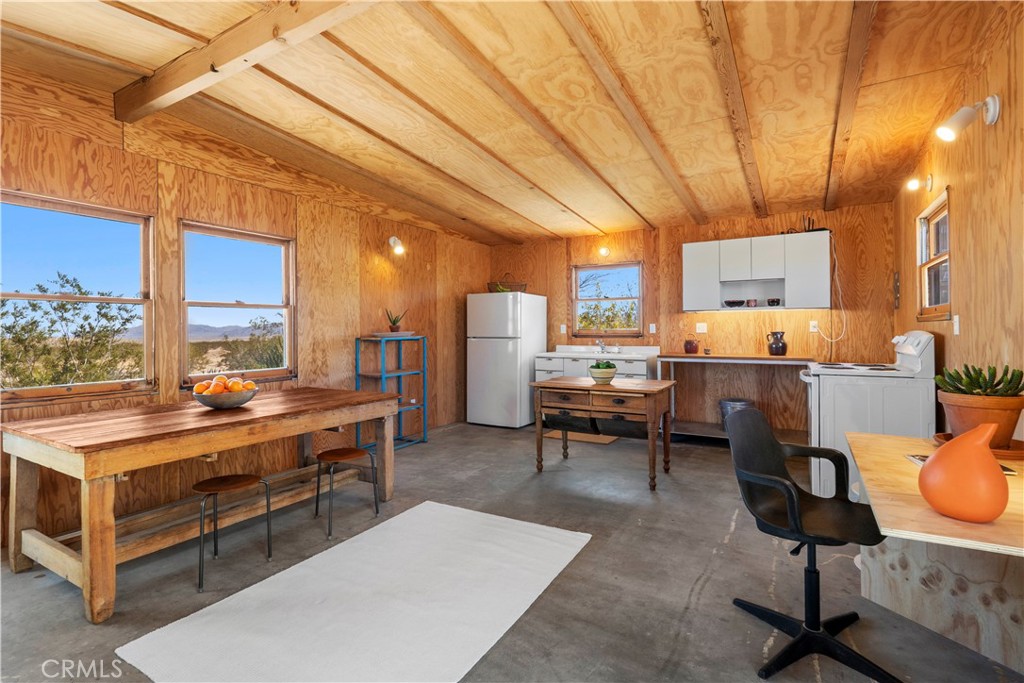 1356 Enchanted Road Joshua Tree, CA 92252 - Photo 8 of 47 a room with furniture a rug and a window