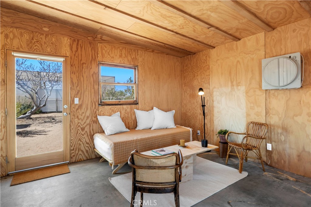 1356 Enchanted Road Joshua Tree, CA 92252 - Photo 9 of 47 a living room with furniture and a window