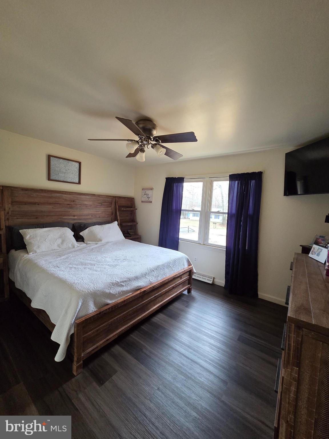 64 Rosedale Drive Bridgeton, NJ 08302 - Photo 10 of 16 a bedroom with a bed and wooden floor