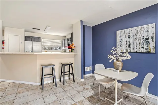 a kitchen with granite countertop a dining table and chairs