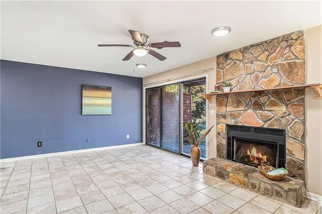 a view of a livingroom with a fireplace and window