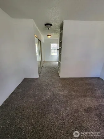 a view of a big room with closet and windows