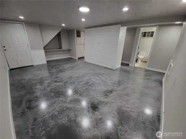an empty room with a kitchen space and yard