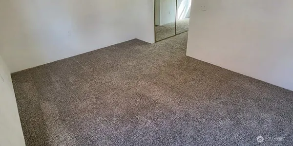 a view of a big room with closet in background
