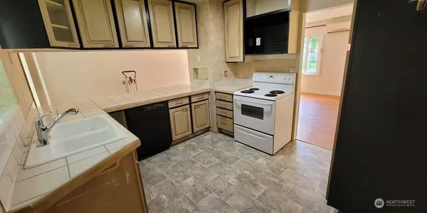 a kitchen with a sink and a stove top oven