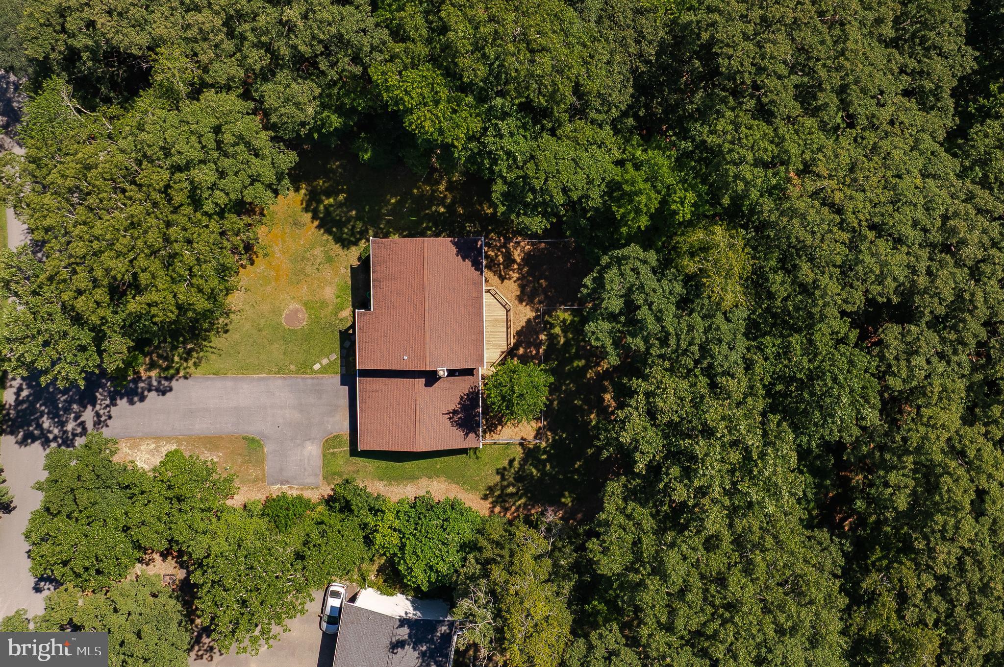 22373 Enoch Road Leonardtown, MD 20650 - Photo 68 of 74 an aerial view of a house with a yard and garden