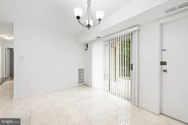 a view of a room with wooden floor and windows