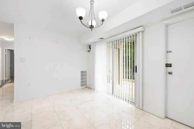 a view of a room with wooden floor and windows