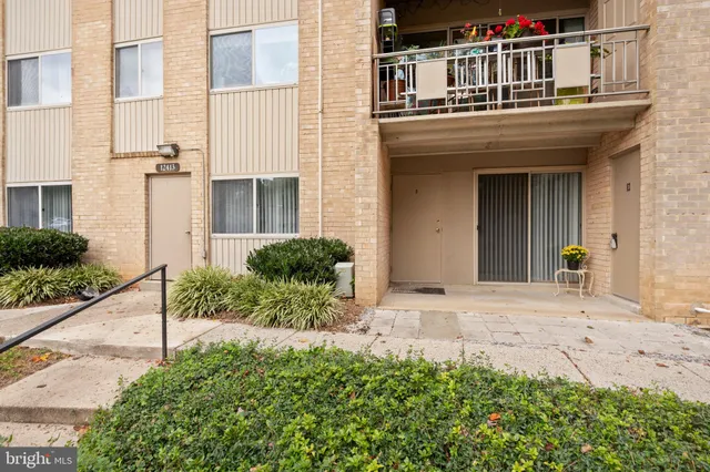 a backyard of a house with barbeque oven table and chairs