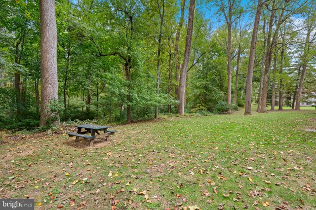 a view of a patio with table and chairs a barbeque