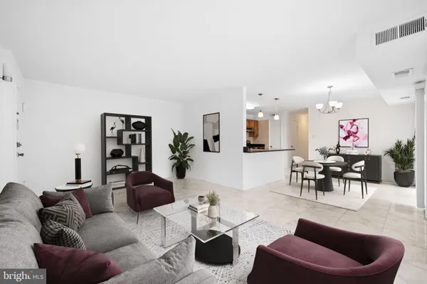 a living room with furniture kitchen view and a window