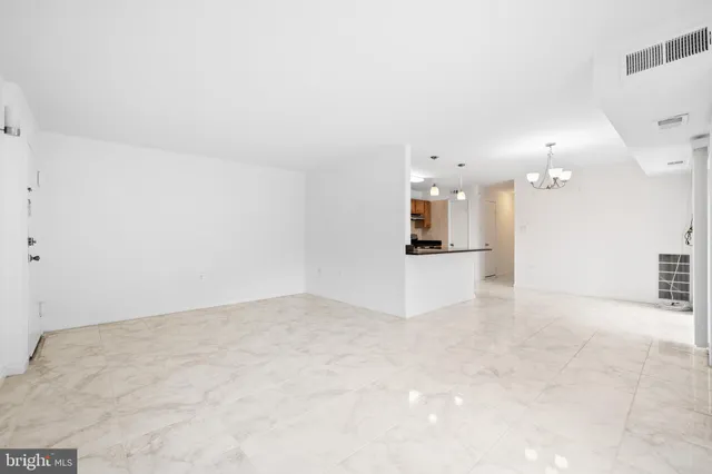 an empty room with a kitchen and a sink