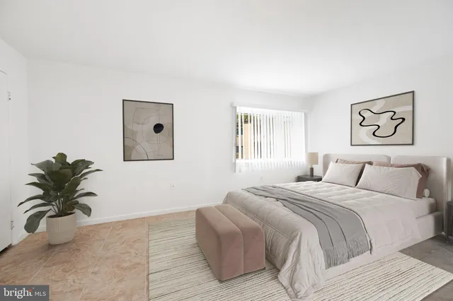 a bedroom with a bed and a couch