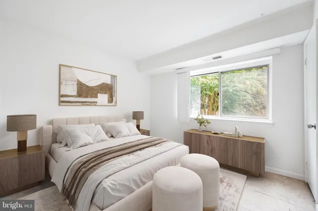 a bedroom with a bed and a window