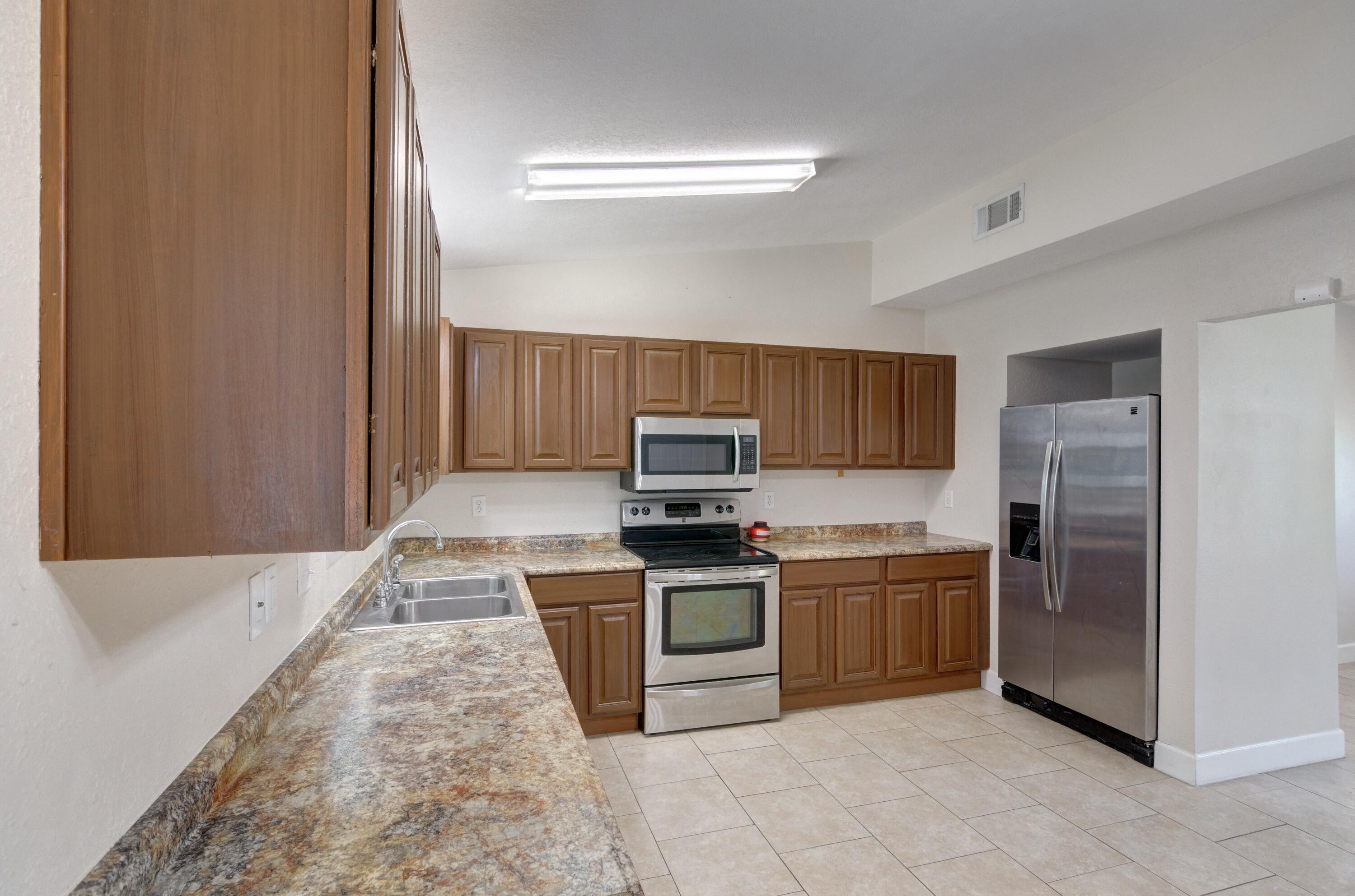 419 Westminster Road Fort Walton Beach, FL 32547 - Photo 13 of 40 a kitchen with stainless steel appliances granite countertop a stove top oven and sink