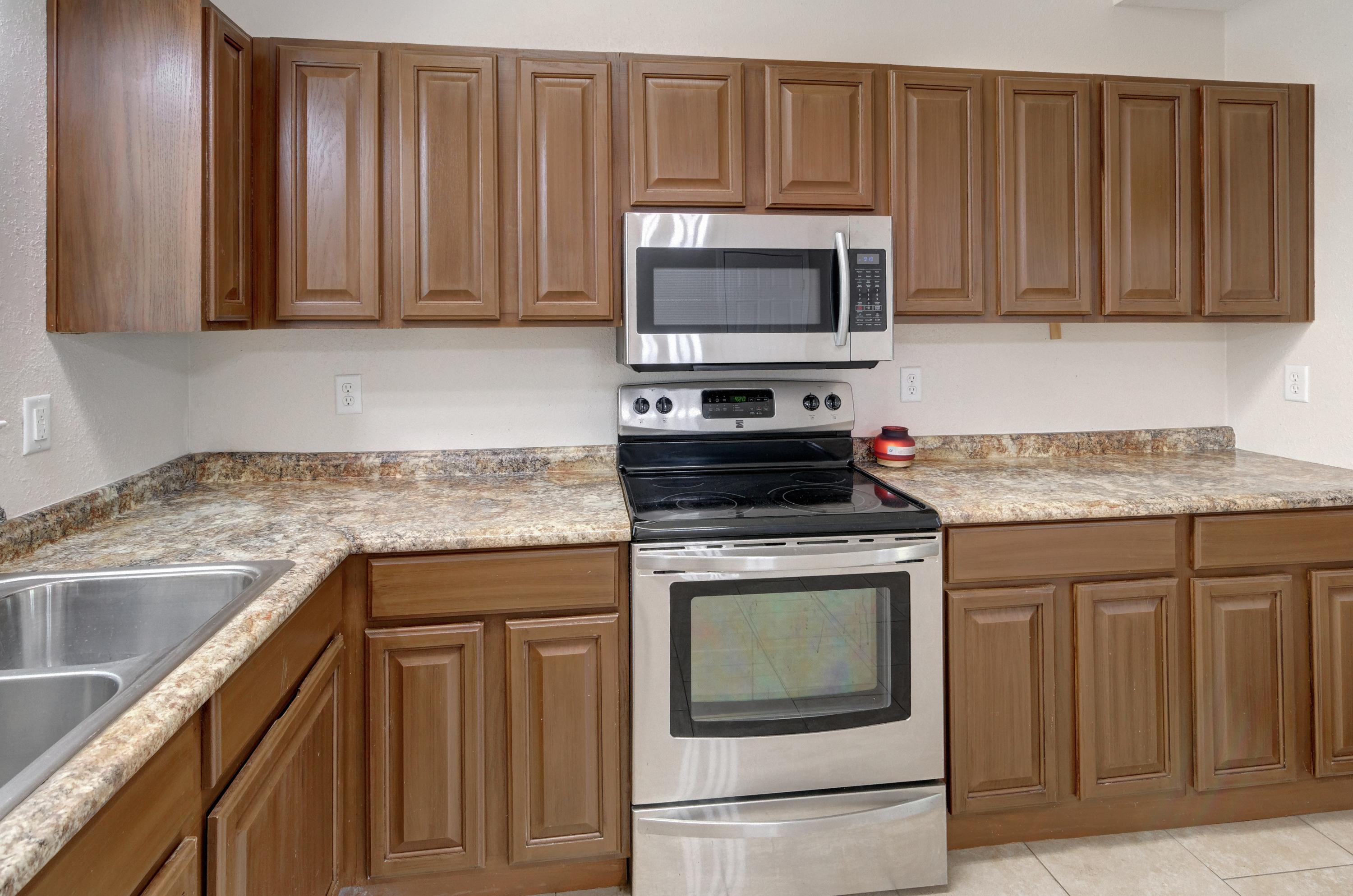 419 Westminster Road Fort Walton Beach, FL 32547 - Photo 15 of 40 a kitchen with granite countertop wood cabinets stainless steel appliances and a sink