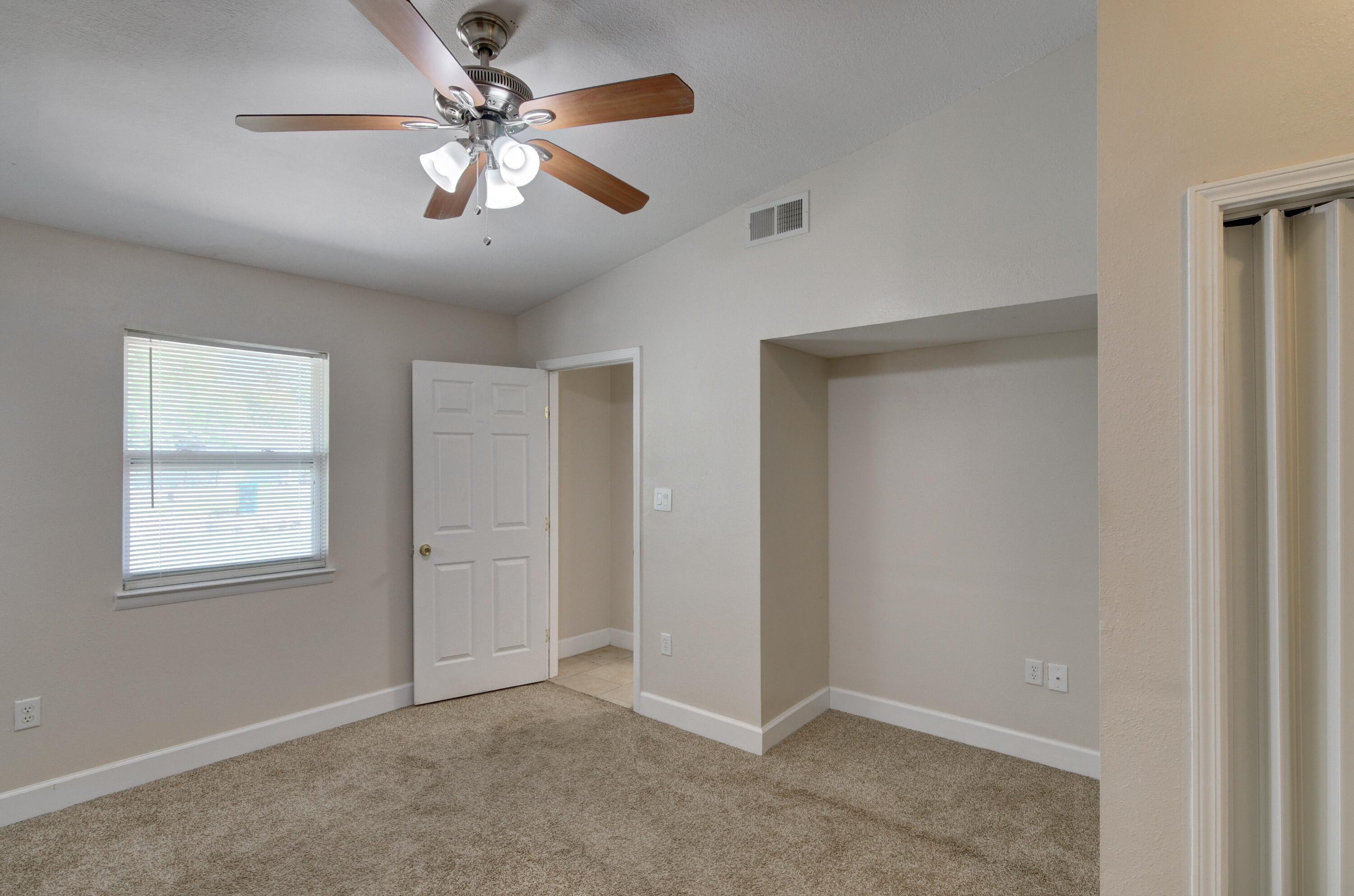 419 Westminster Road Fort Walton Beach, FL 32547 - Photo 17 of 40 an empty room with windows and fan