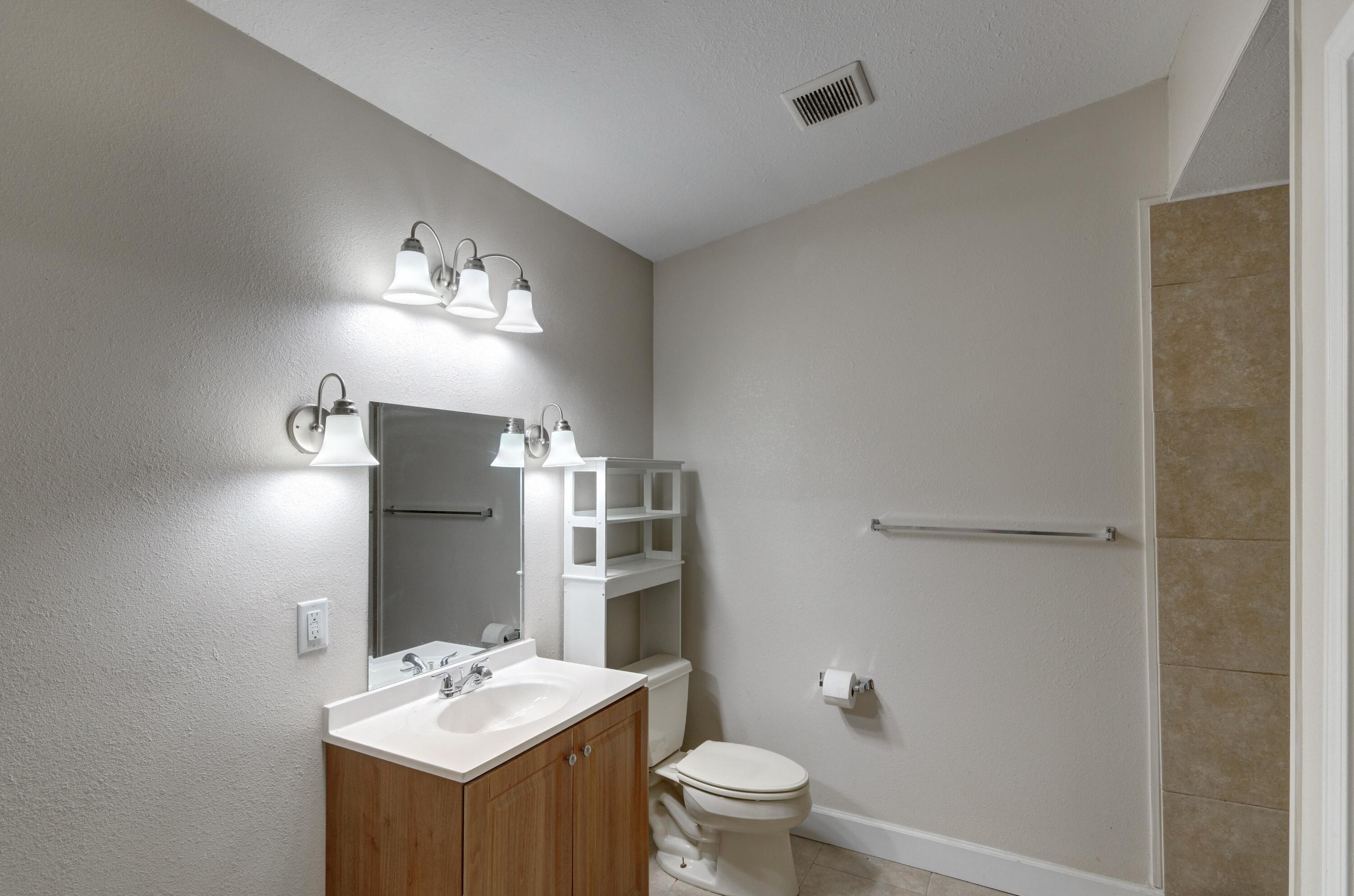 419 Westminster Road Fort Walton Beach, FL 32547 - Photo 19 of 40 a bathroom with a toilet sink and mirror