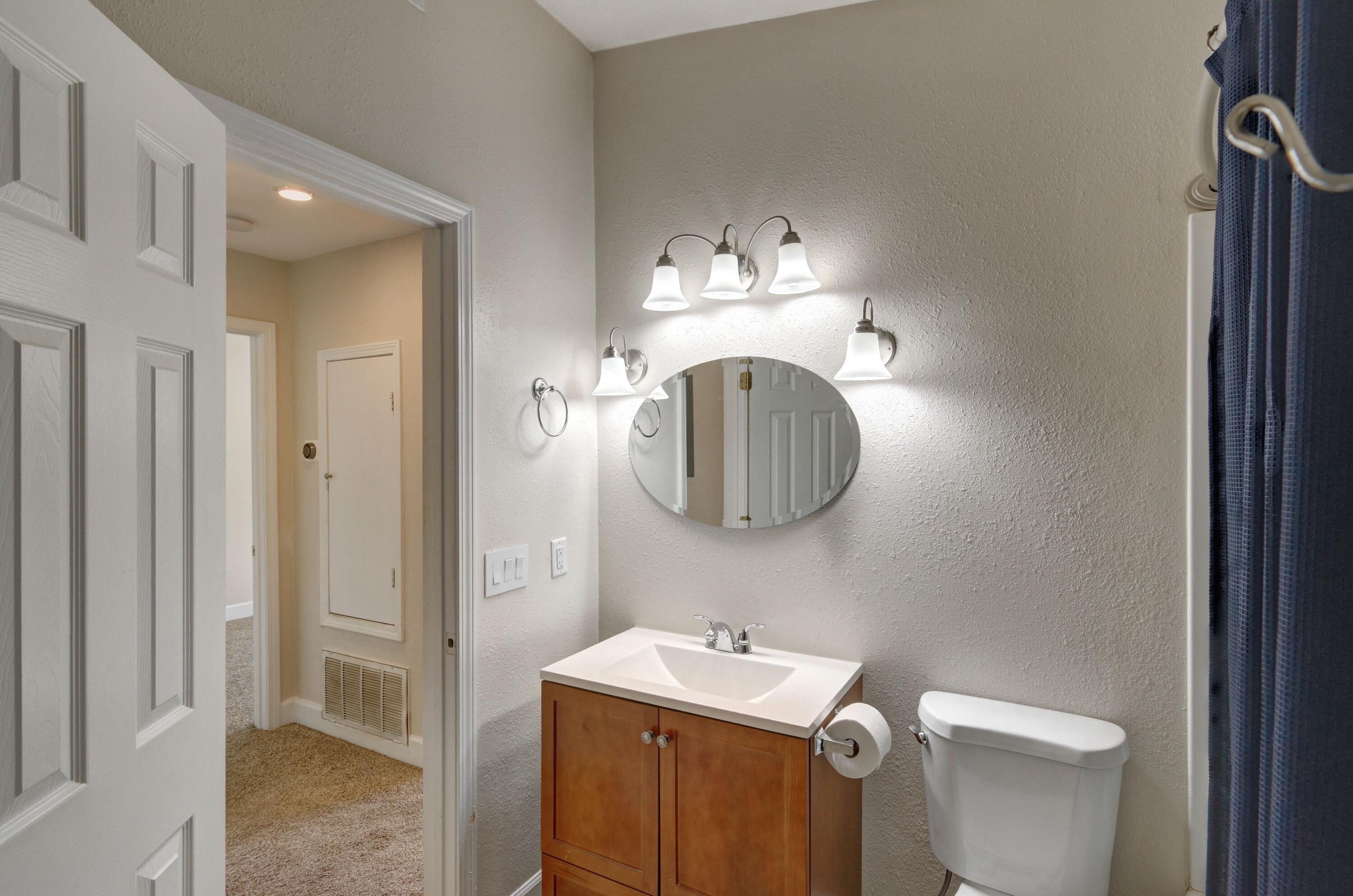 419 Westminster Road Fort Walton Beach, FL 32547 - Photo 26 of 40 a bathroom with a toilet a sink and mirror