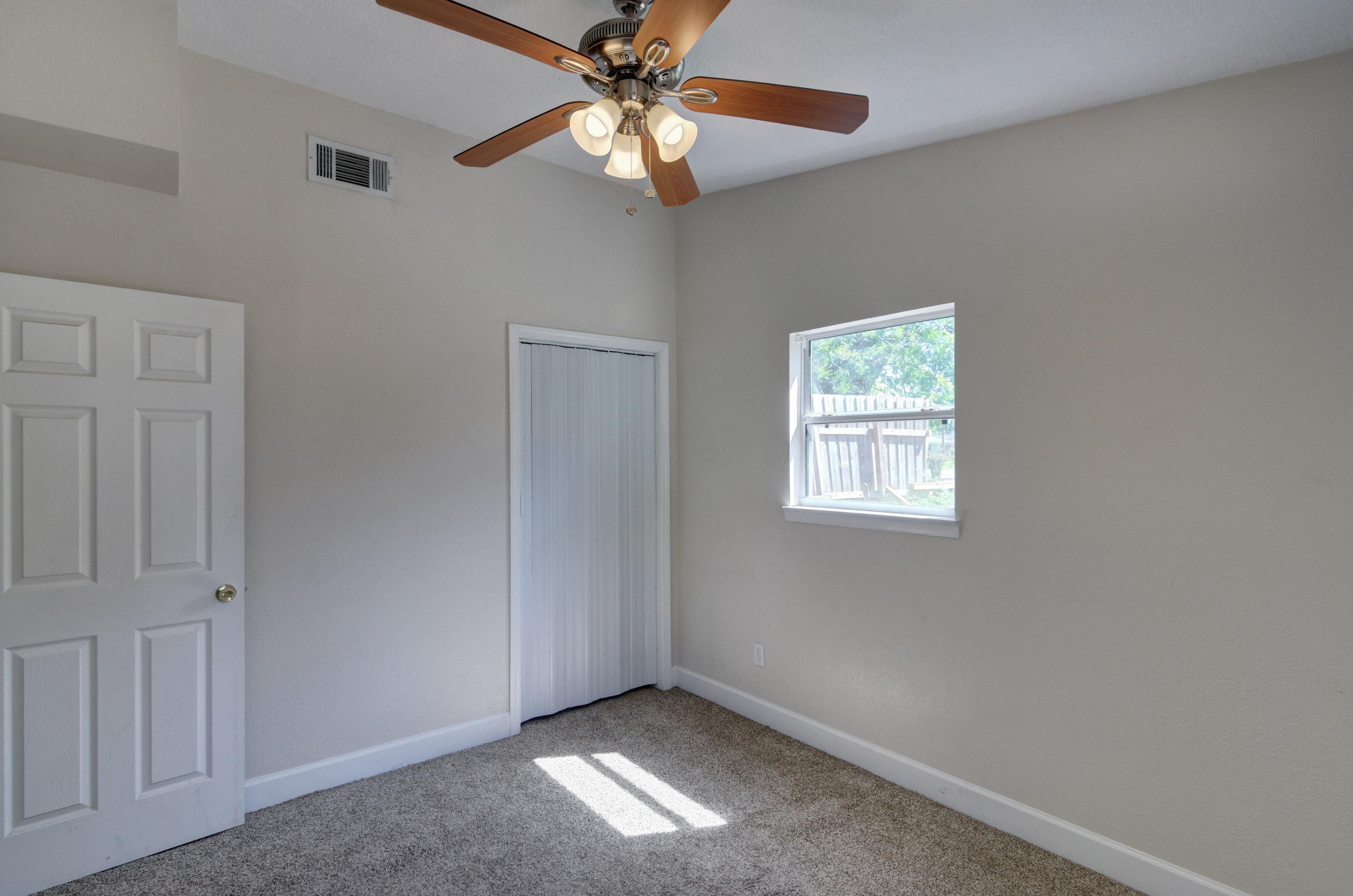 419 Westminster Road Fort Walton Beach, FL 32547 - Photo 29 of 40 an empty room with windows and fan