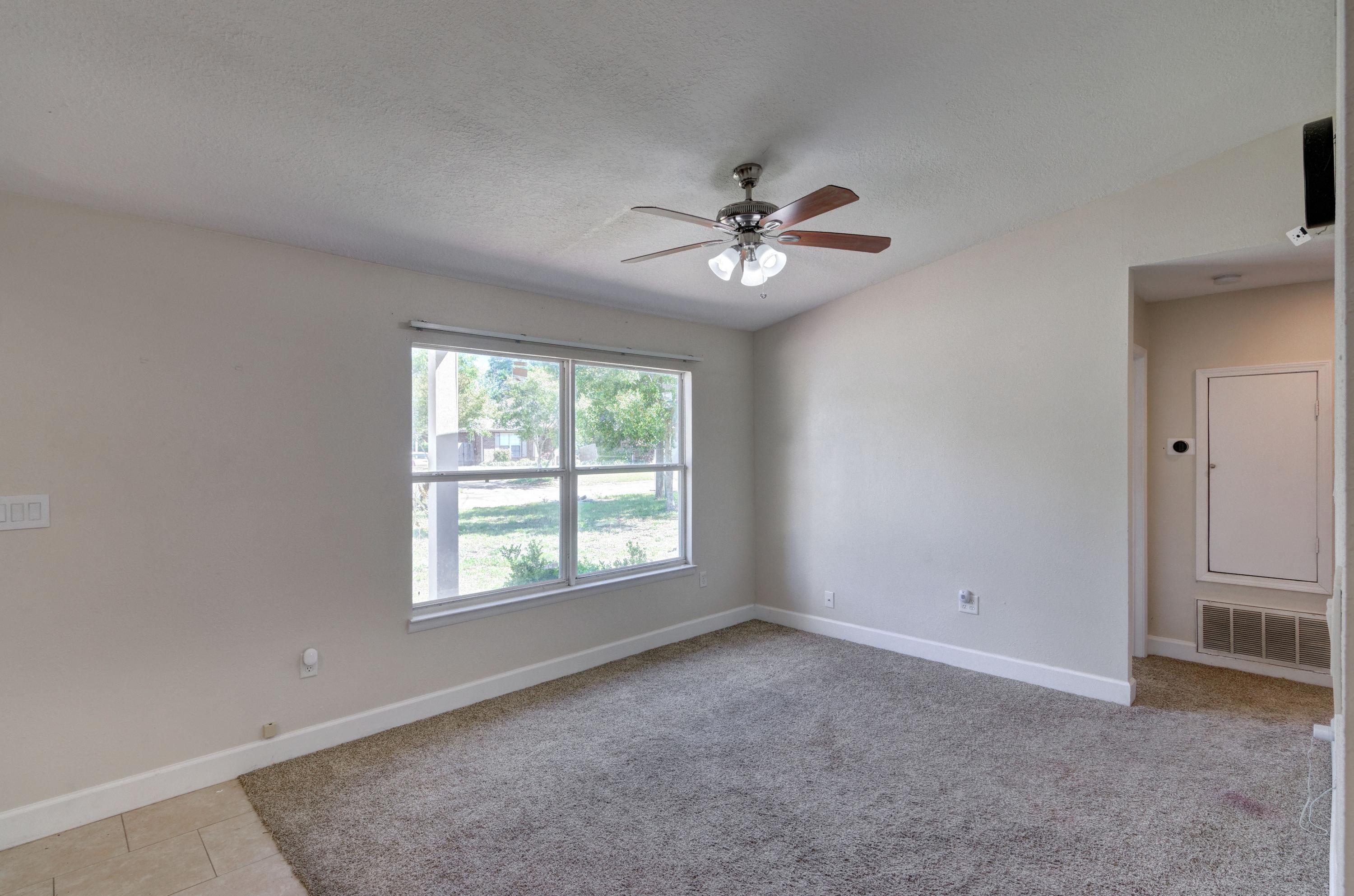 419 Westminster Road Fort Walton Beach, FL 32547 - Photo 7 of 40 an empty room with windows and ceiling fan