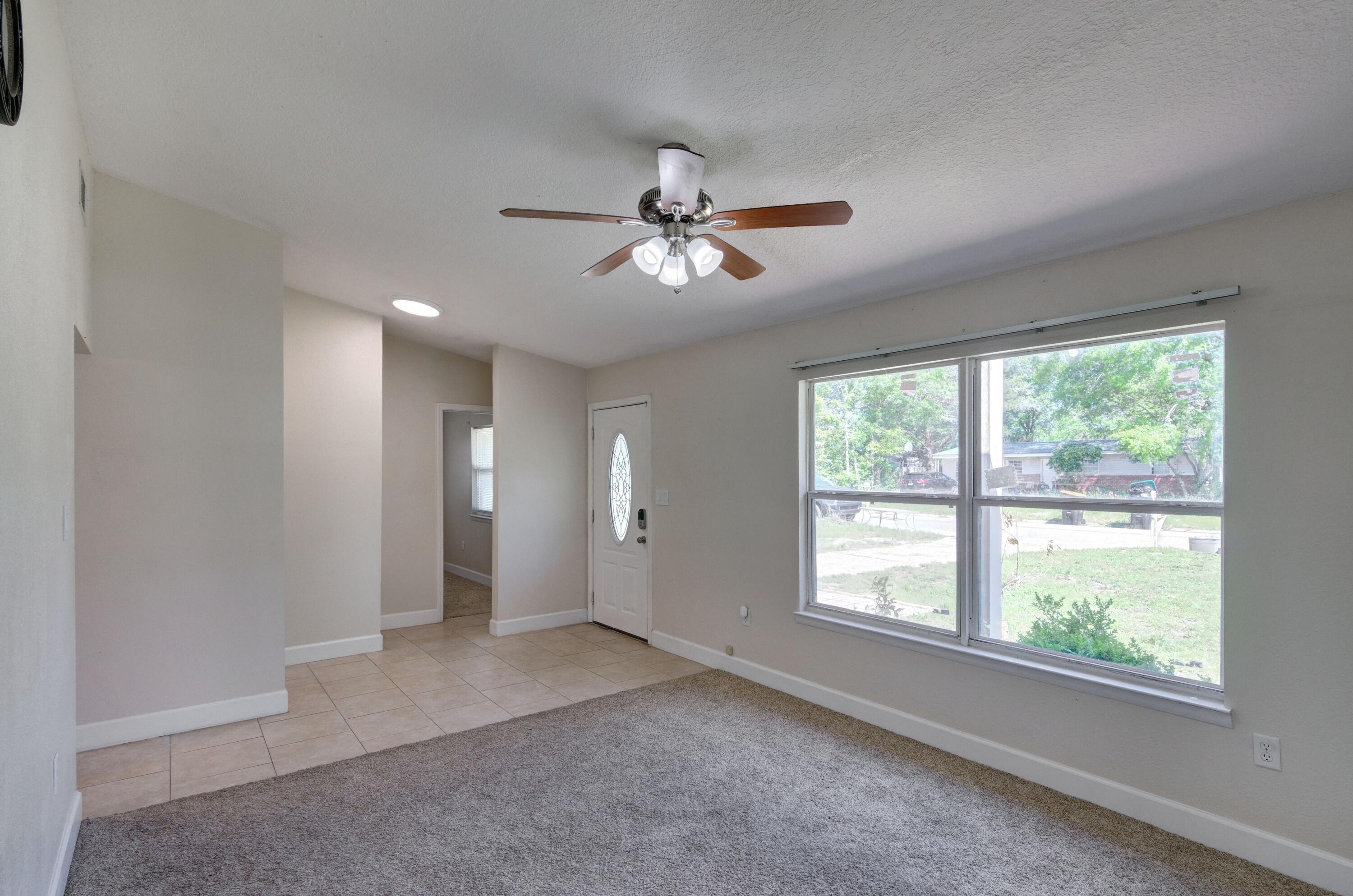419 Westminster Road Fort Walton Beach, FL 32547 - Photo 8 of 40 a view of a livingroom with a ceiling fan and window