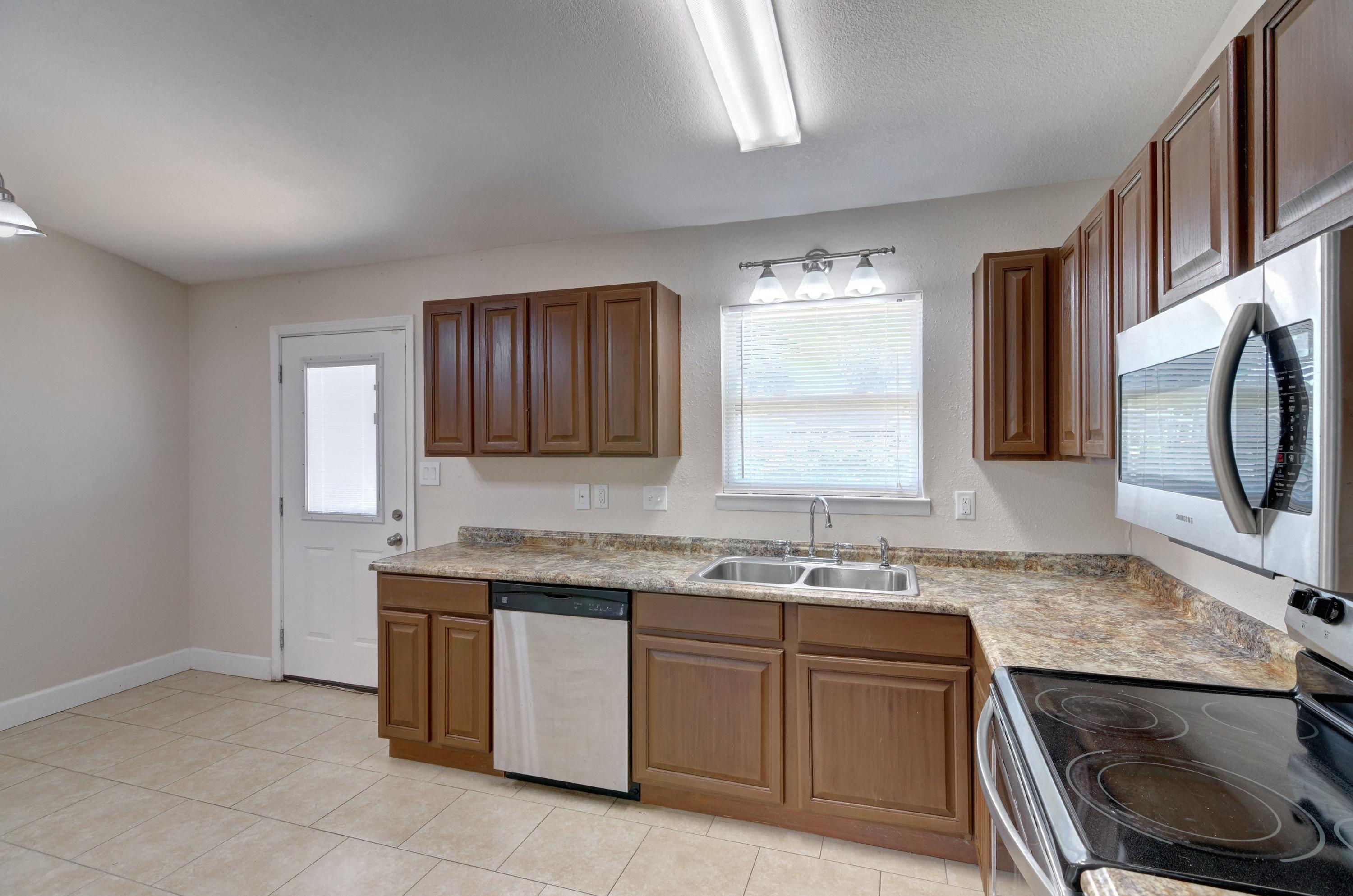 419 Westminster Road Fort Walton Beach, FL 32547 - Photo 10 of 40 a kitchen with stainless steel appliances granite countertop a sink stove and cabinets
