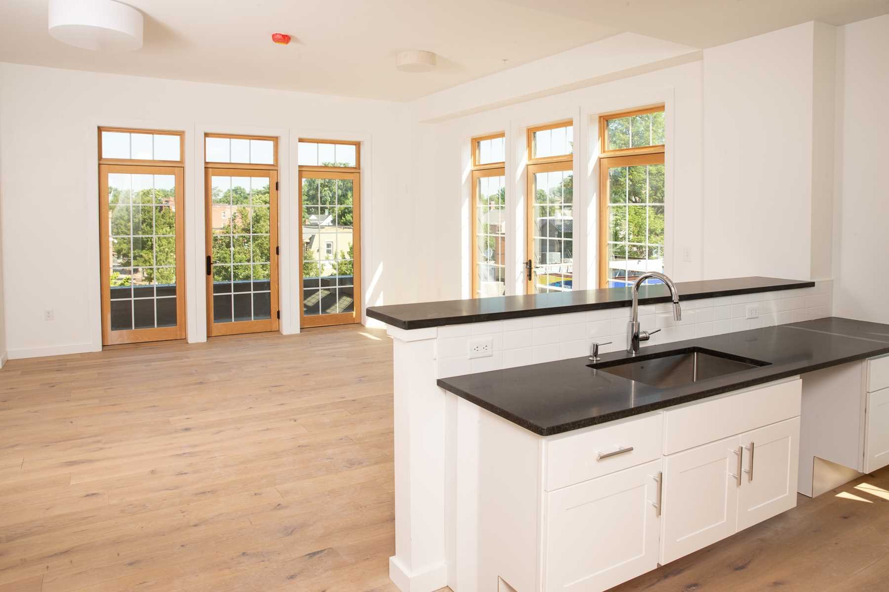 a kitchen with granite countertop a sink and a large window