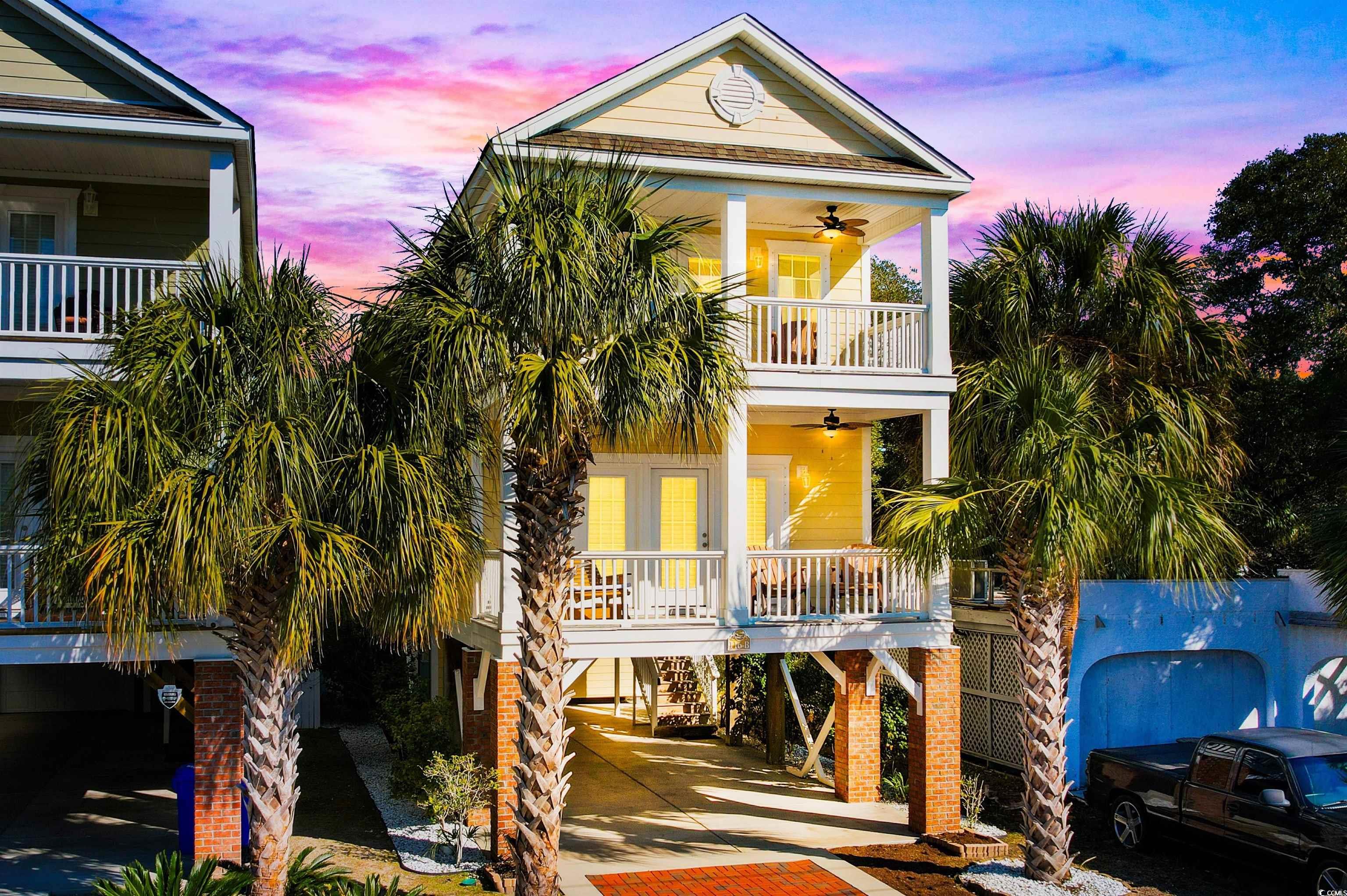 Beach home featuring a carport, ceiling fan, cover