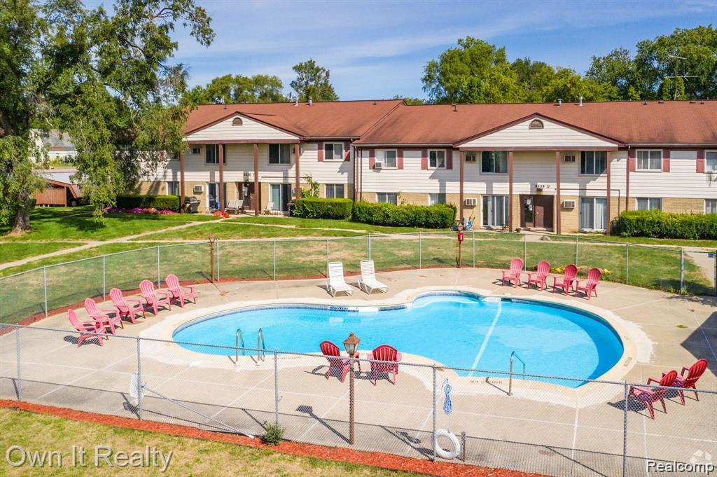 59314 Van Dyke Road Washington, MI 48094 - Photo 4 of 16 Community pool featuring a patio area