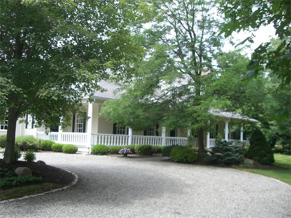 75 Salem Road Topsfield, MA 01983 - Photo 3 of 25 a front view of a house with a garden and plants