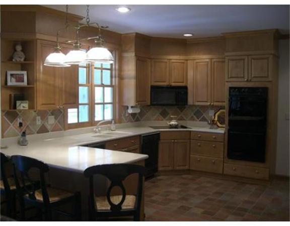 75 Salem Road Topsfield, MA 01983 - Photo 10 of 25 a kitchen with kitchen island granite countertop a sink cabinets and stove top oven