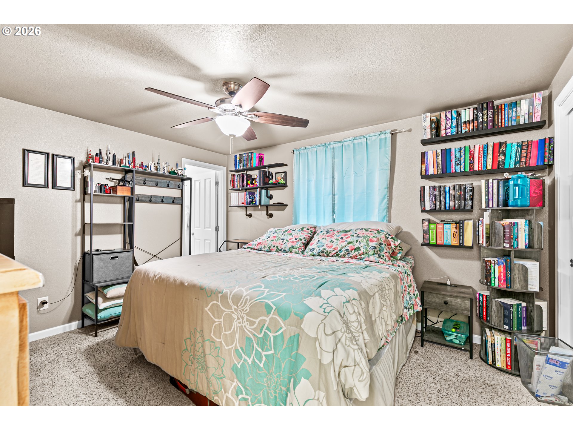 3712 Colver Road Phoenix, OR 97535 - Photo 12 of 38 a bedroom with a bed a book shelf and a book shelf
