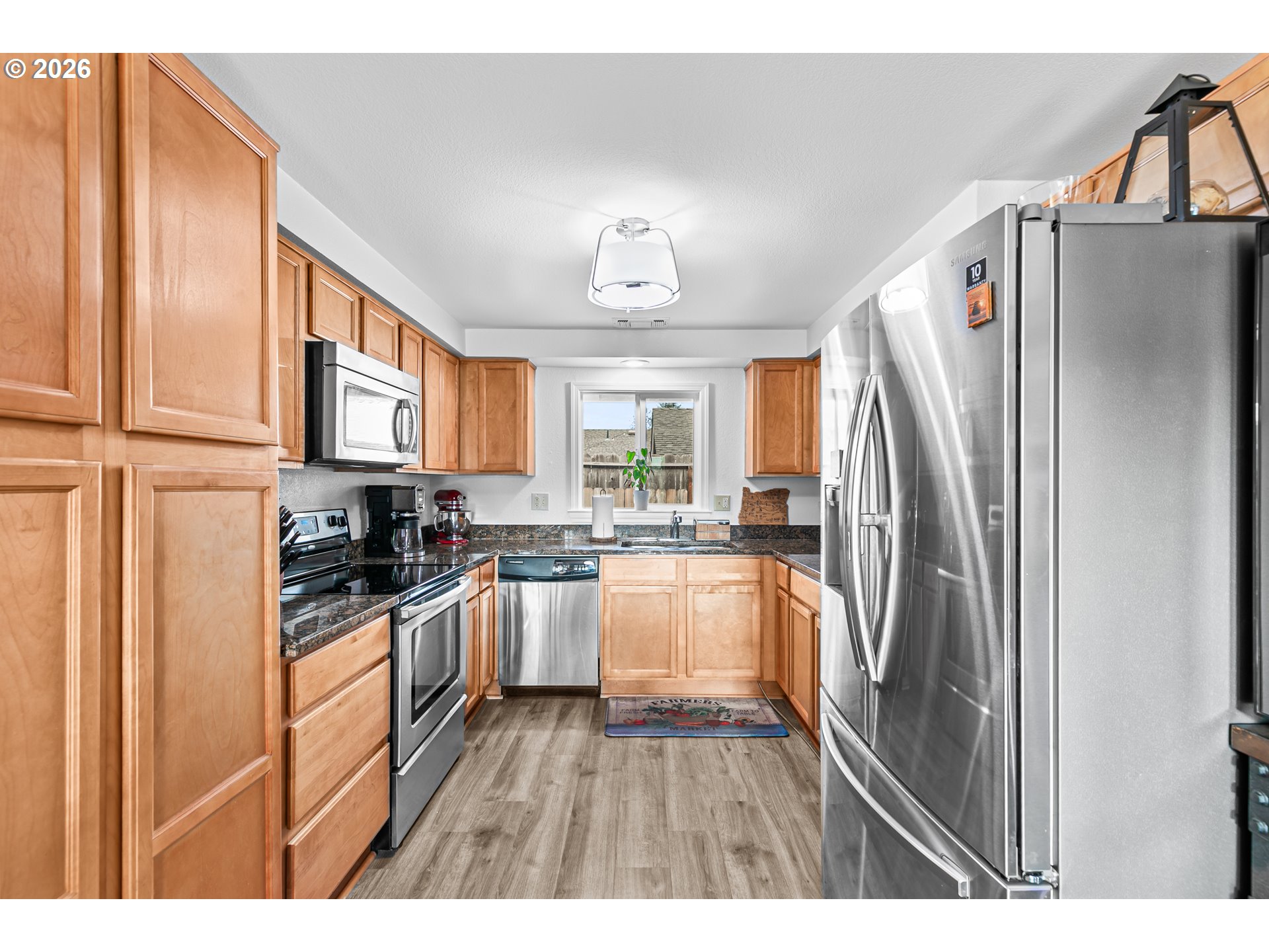 3712 Colver Road Phoenix, OR 97535 - Photo 7 of 38 a kitchen with stainless steel appliances a refrigerator sink and cabinets