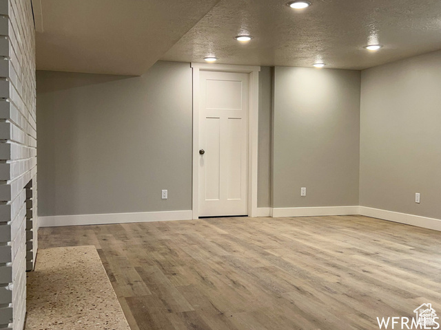 702 North 100 West Logan, UT 84321 - Photo 13 of 58 Finished below grade area featuring a textured ceiling, baseboards, and light wood-type flooring
