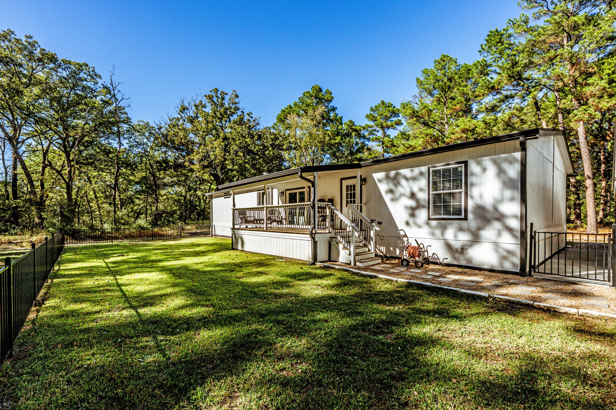 485 Fm 230 Trinity, TX 75862 - Photo 45 of 50 Covered back deck and wrought iron fenced backyard