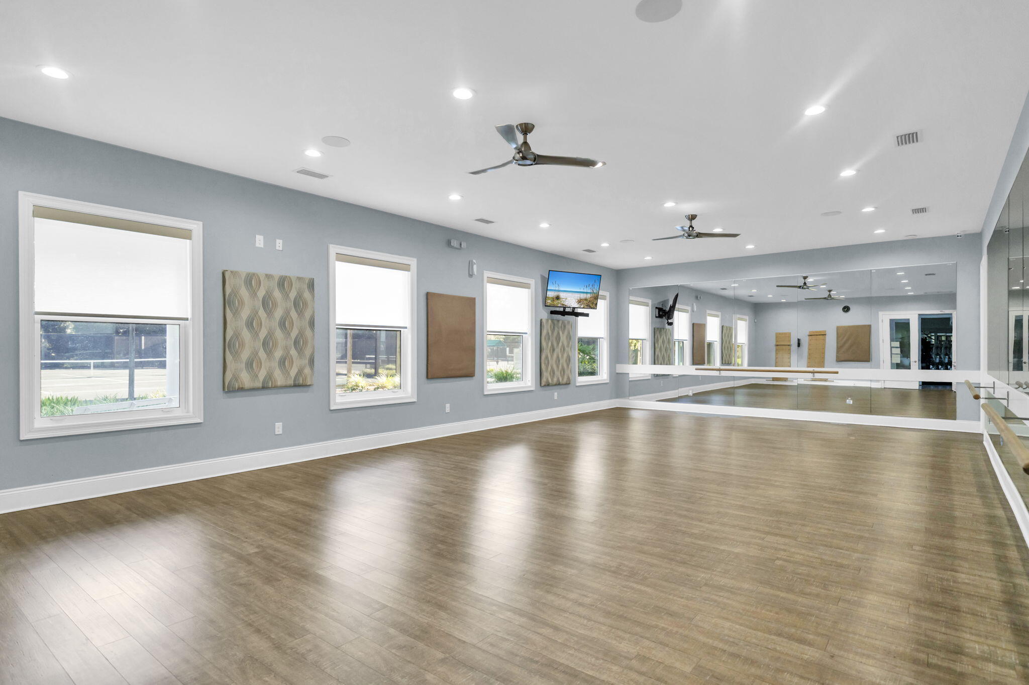236 Mattie's Way Destin, FL 32541 - Photo 111 of 156 a view of an empty room with wooden floor and a window