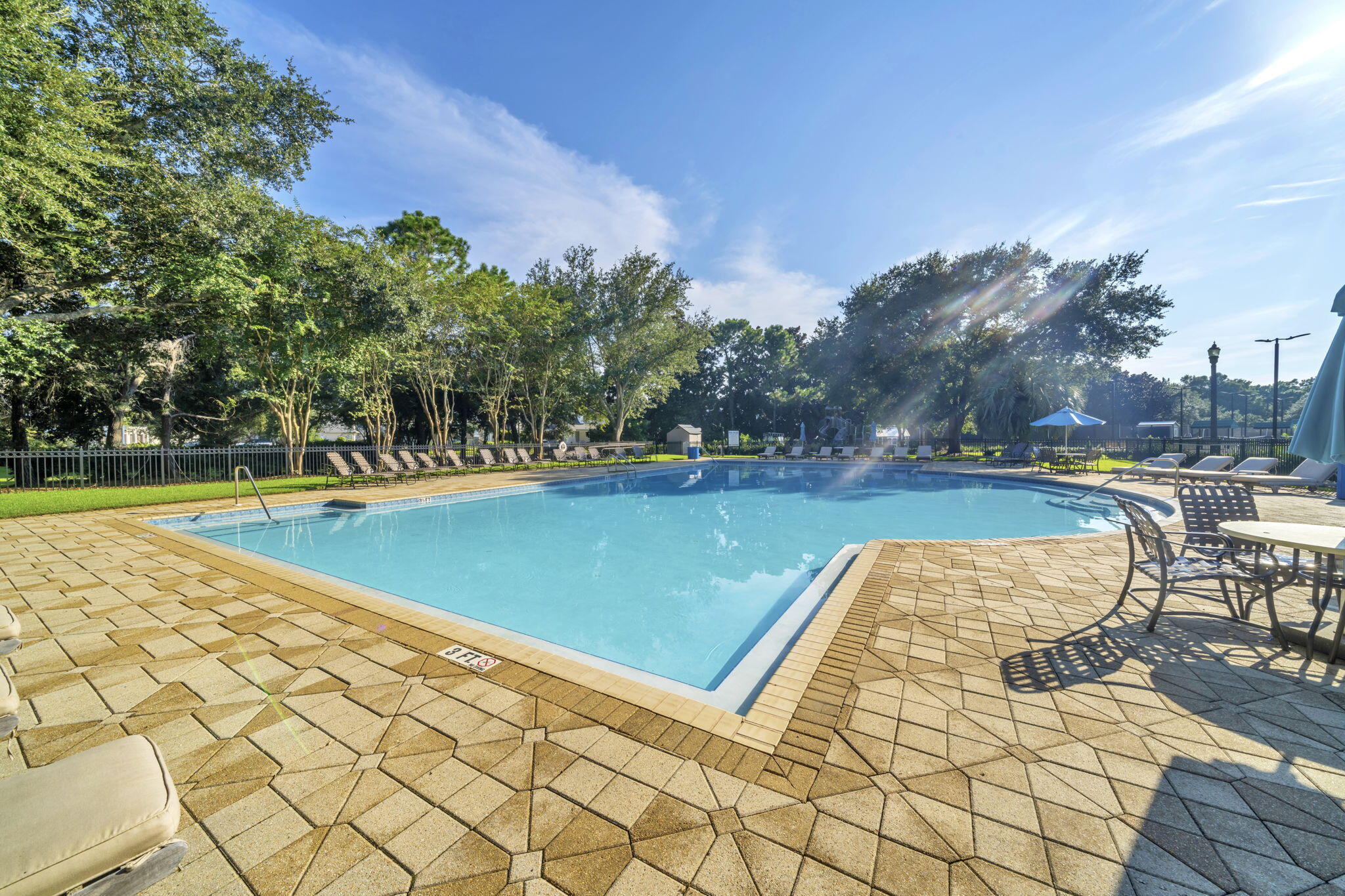 236 Mattie's Way Destin, FL 32541 - Photo 120 of 156 a view of swimming pool with seating space and trees in the background