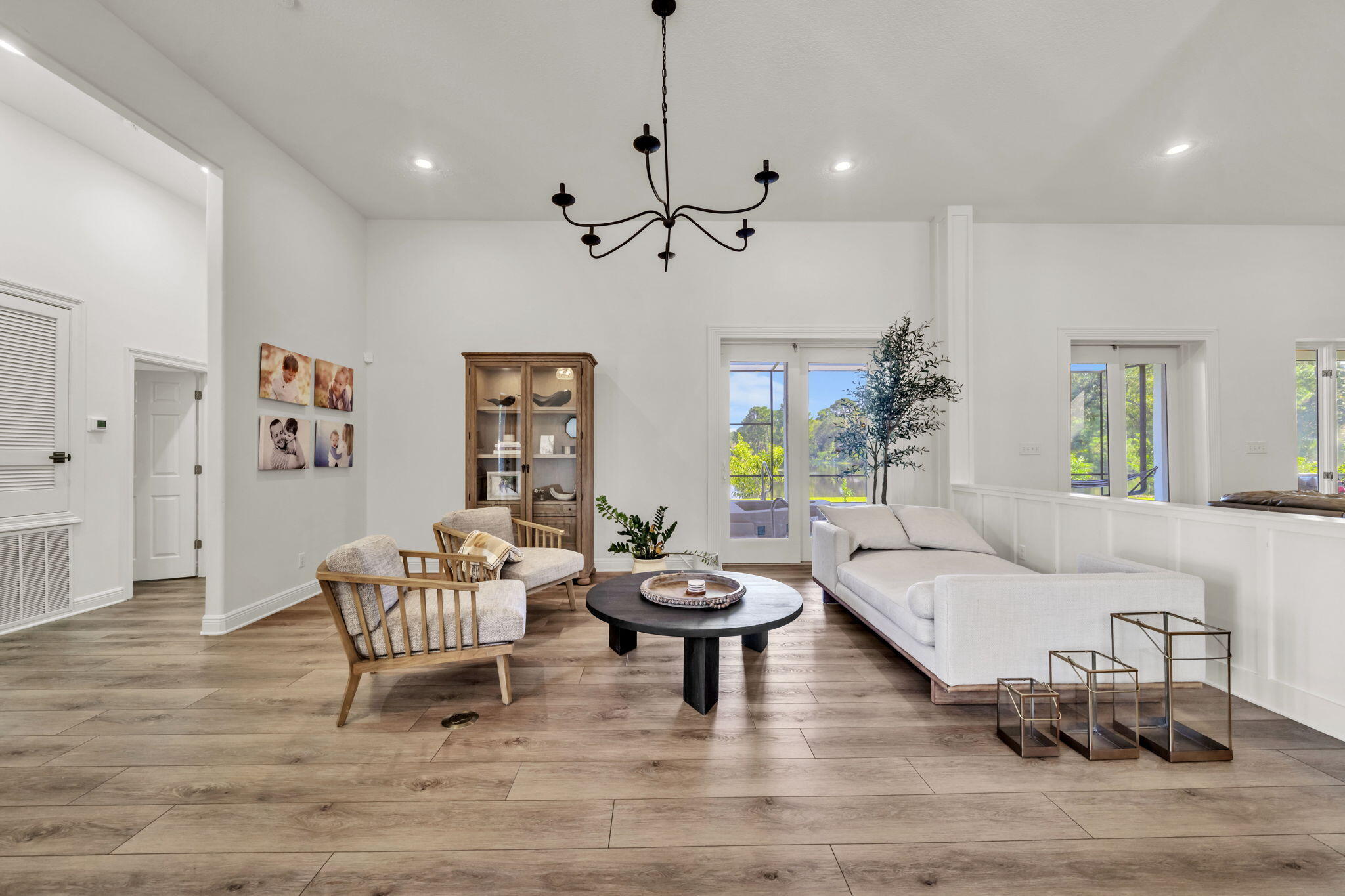236 Mattie's Way Destin, FL 32541 - Photo 24 of 156 a living room with furniture a chandelier and a window