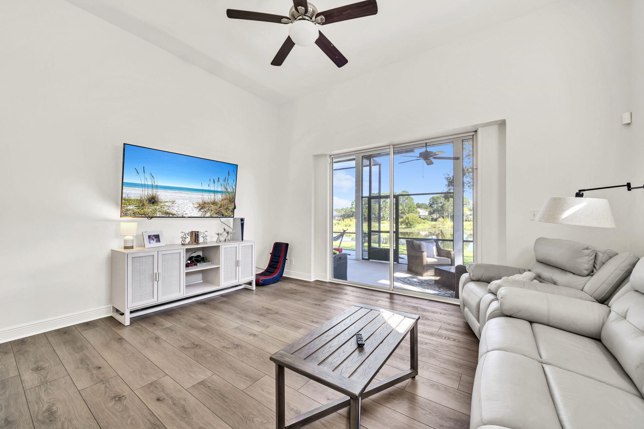 236 Mattie's Way Destin, FL 32541 - Photo 44 of 156 a living room with furniture a fireplace and a floor to ceiling window