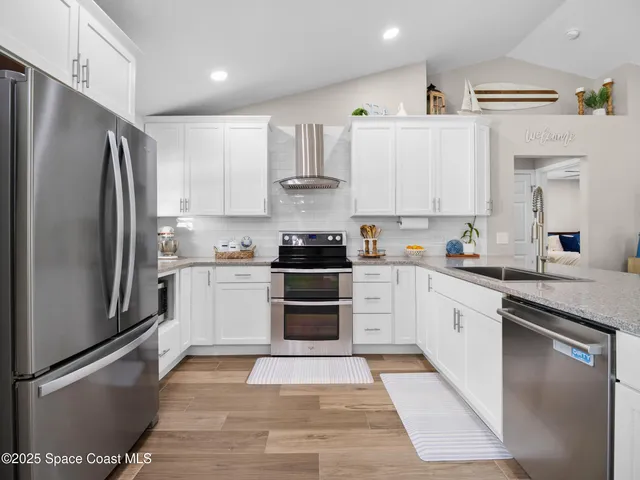 a kitchen with stainless steel appliances cabinets a sink and a counter top space