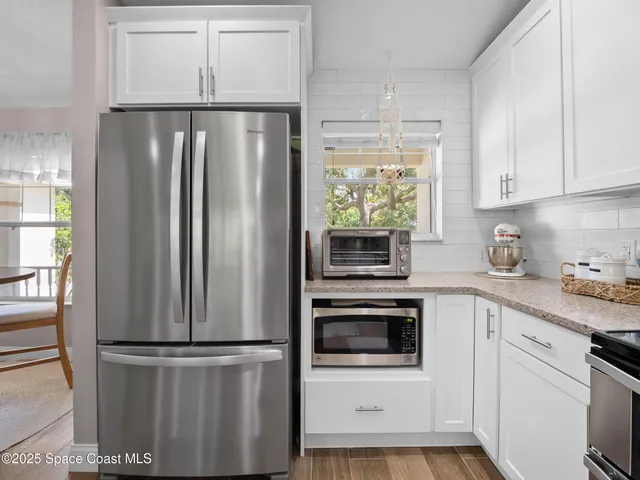 a kitchen with stainless steel appliances a refrigerator sink and cabinets