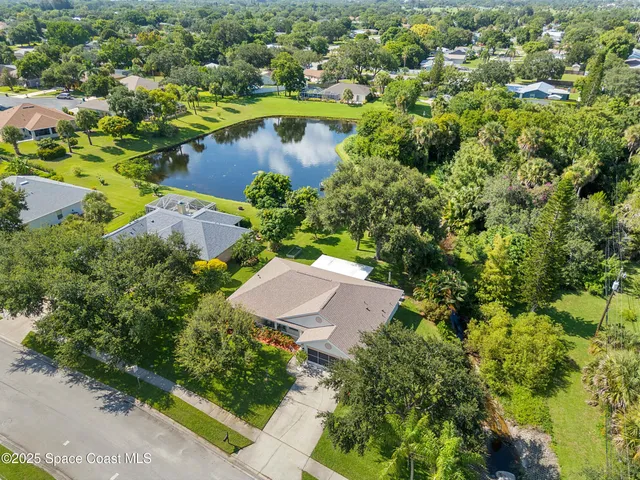 an aerial view of residential house with outdoor space and swimming pool