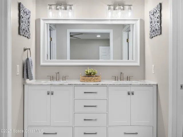 a bathroom with cabinets and mirror