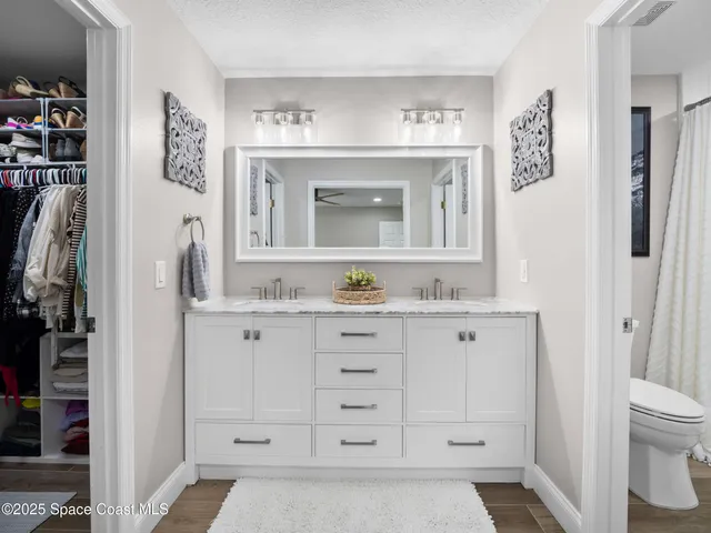a bathroom with a granite countertop sink vanity mirror bathtub shower