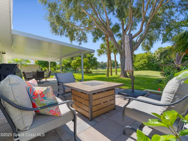 a backyard of a house with outdoor seating