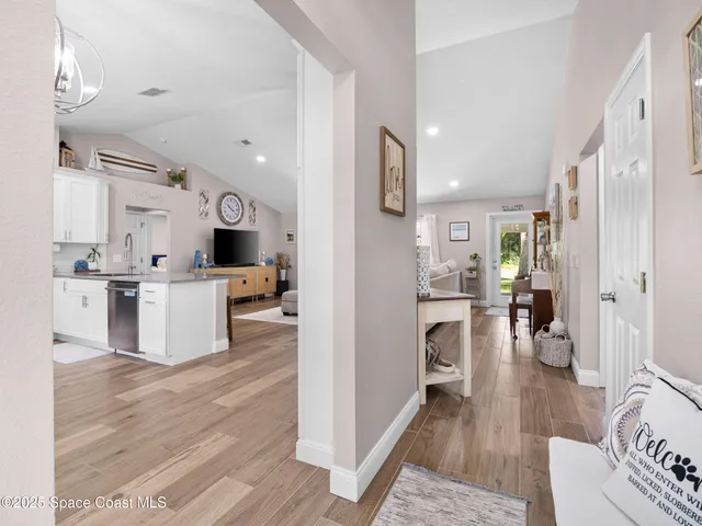 a open kitchen with cabinets and wooden floor